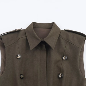 Detail of olive sleeveless trench vest with epaulettes and dark tortoiseshell buttons