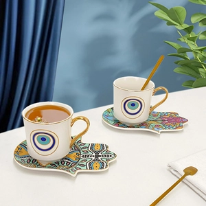 Ceramic Evil Eye coffee cup set with gold trim and Hamsa hand shaped saucers
