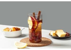 Close-up of stacked heat-resistant borosilicate glass cup with fruit infused tea and cinnamon
