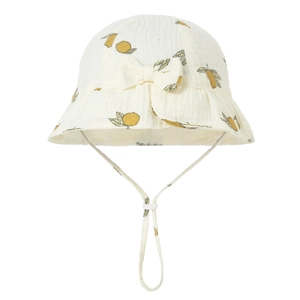Macro detail of breathable cotton baby sun hat featuring lemon print and adjustable bow