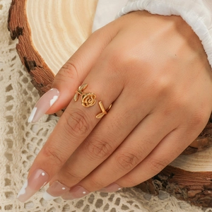 Elegant 3D rose and leaf open ring in gold plated brass on a model's hand