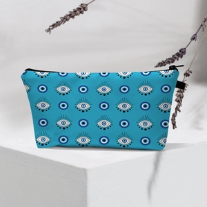 Waterproof Evil Eye makeup bag on white pedestal with dried lavender decoration