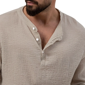 Detailed close-up of khaki cotton linen texture on a men's long sleeve Henley shirt
