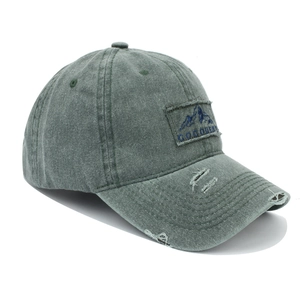 Distressed army green washed baseball cap with GOQUEST mountain patch and vintage wear details