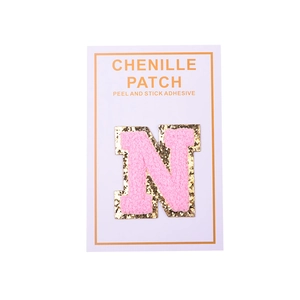 Close-up of pink chenille letter N patch with gold sequins and self-adhesive backing