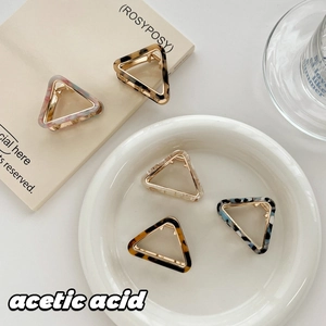 Stylish triangle acetic acid hair claws in various marble and tortoiseshell patterns