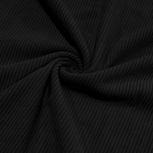 Detailed macro shot of black corduroy fabric showing the ribbed texture and soft finish