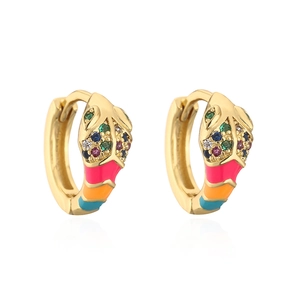 Close-up of gold snake earrings with colorful zircon stones and vibrant enamel details