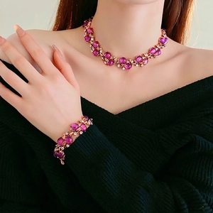 Vintage rose gold jewelry set with purple gemstones and floral leaf diamond details