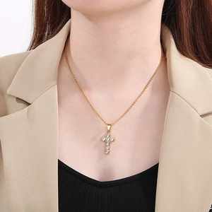 Golden titanium steel cross pendant necklace with diamonds on a male model's neck