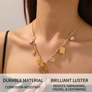 Detail of boho braided rope necklace with floral heart charms and golden pendants