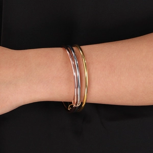 Detail of 3mm interlocking stainless steel bangles in gold, silver, and rose gold finishes