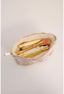 Detail view of pink floral embroidered makeup bag showing large capacity and zipper