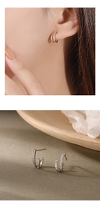Detail of 925 silver double hoop earrings with cubic zirconia and 18K gold plating