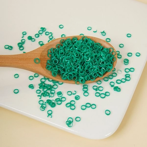Green PVC artificial chopped green onion rings for DIY food props in a wooden spoon