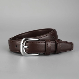 Detailed view of women's brown leather belt with shiny silver metal pin buckle and neat stitching.