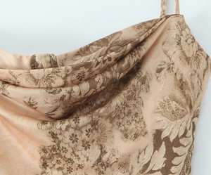 Detailed view of the draped neckline on a floral satin slip dress with brown flower prints