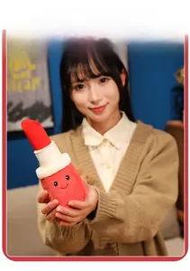 Creative plush lipstick keychain held by hand to show soft texture and compact size
