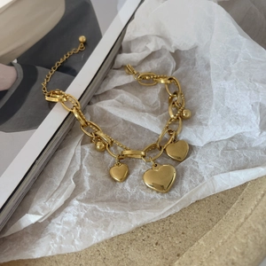 Double-layered 18K gold plated titanium steel bracelet featuring multiple heart charms