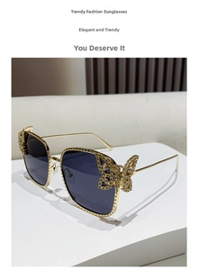 Detailed macro view of rhinestone butterfly accents on gold metal square sunglasses
