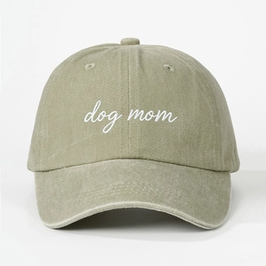 Detailed view of dog mom white embroidery on washed cotton baseball cap fabric