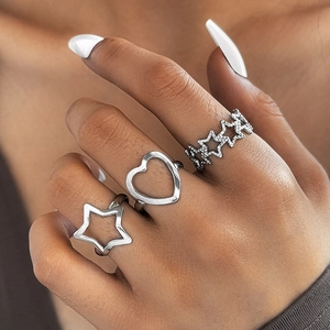Three-piece silver stainless steel ring set featuring hollow heart and star motifs