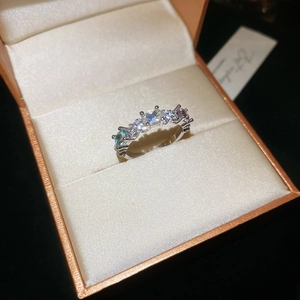 Close-up of silver ring with multicolored zircons in jewelry box display