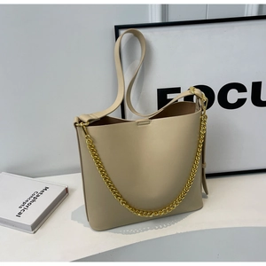 Chic beige PU leather tote bag with elegant gold chain strap and adjustable shoulder strap