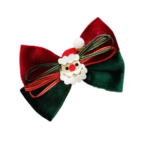 Christmas velvet hair clip with red and green bow and glittery Santa Claus embellishment