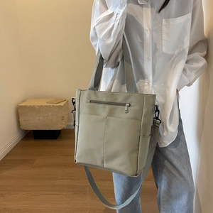 Minimalist khaki canvas tote bag with adjustable shoulder strap and large capacity