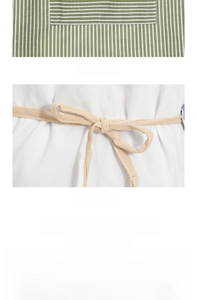 Detail of striped canvas apron featuring functional split pockets and durable fabric texture