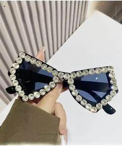 Close-up of sparkling crystals on black oversized butterfly sunglasses frame