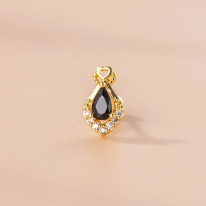 Detailed view of gold teardrop stud earring with black stone and heart design