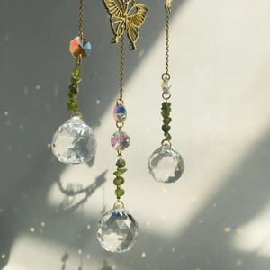 Detailed suncatcher view with golden butterfly and faceted crystal balls casting light