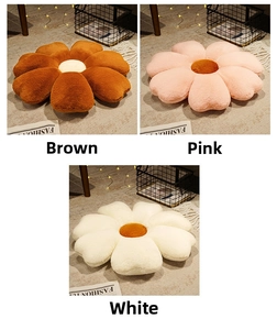 Plush flower-shaped pillows in brown, pink, and white on a cozy home rug