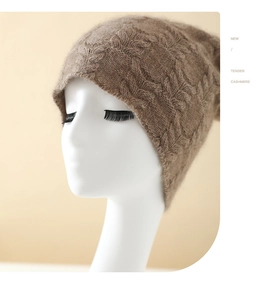Close-up detail of cashmere knit beanie featuring a 3D cable pattern and soft texture