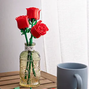 Three artificial building block red roses in clear glass vase for romantic home decor