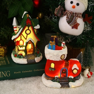 Lighted Christmas cottage and gift boot figurines with snow texture and warm LED glowing light