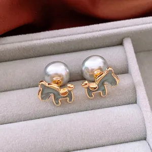 Elegant 18K gold-plated poodle stud earrings with grey pearls on velvet display