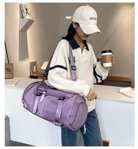 Detail of purple large capacity duffel bag with adjustable strap and waterproof nylon texture