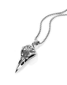 Macro shot of silver viking crow skull pendant with engraved vegvisir compass details