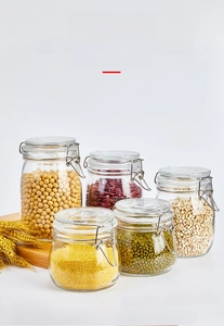 Detail view of five glass airtight jars with stainless steel buckles and grains