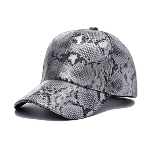 Close-up of silver snakeskin texture on a faux leather baseball cap with curved brim