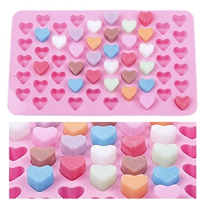 Detailed view of 55-cavity pink silicone heart mold with colorful chocolate candies