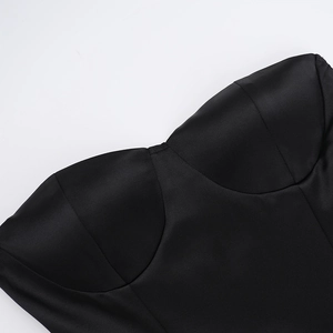 Detail of slim fit black satin tube dress with sweetheart neckline and ruched bodice