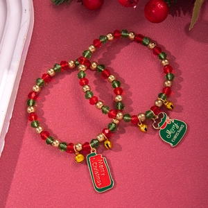 Detail of two Christmas beaded bracelets with red and green crystals and holiday charms