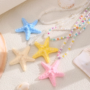 Flat lay of colorful starfish necklaces with shell decor for bohemian summer beach styles