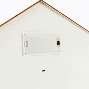Close-up of battery compartment and ON/OFF switch on white house calendar ornament