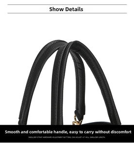 Detail of black pebbled leather double handles with gold metal hooks on handbag