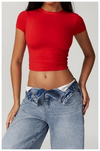 Detail of red slim fit crop top T-shirt paired with high-waist vintage blue jeans